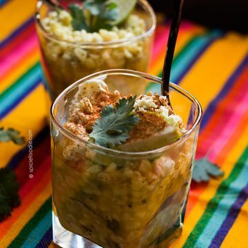Glasses filled with Mexican esquites which are sautéed and stewed fresh corn kernels then served with mayo, cheese, lime and chile pepper.