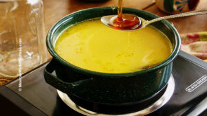 Adding honey to homemade turmeric tea to sweeten it.