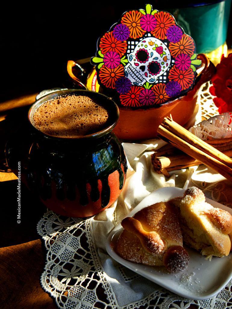 Vegan Mexican hot chocolate served in a traditional mug with some pan dulce on the side.
