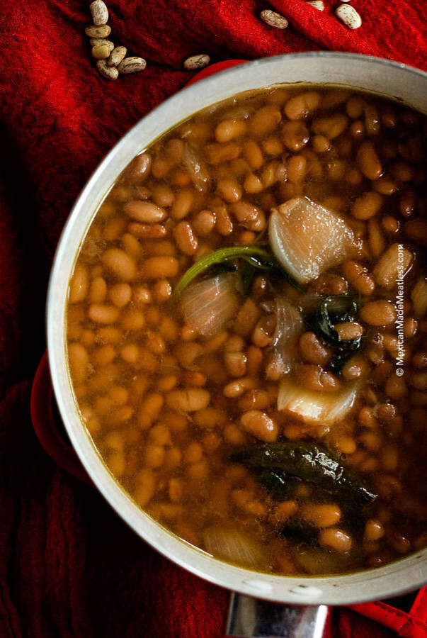 Mexican Vegan pinto beans cooked and inside a white pot.