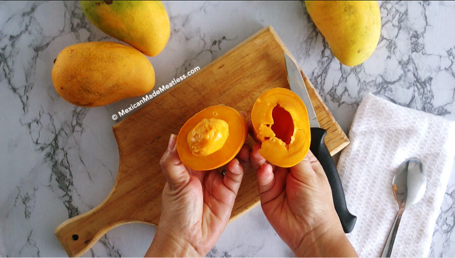 Slicing open a mango to eat.