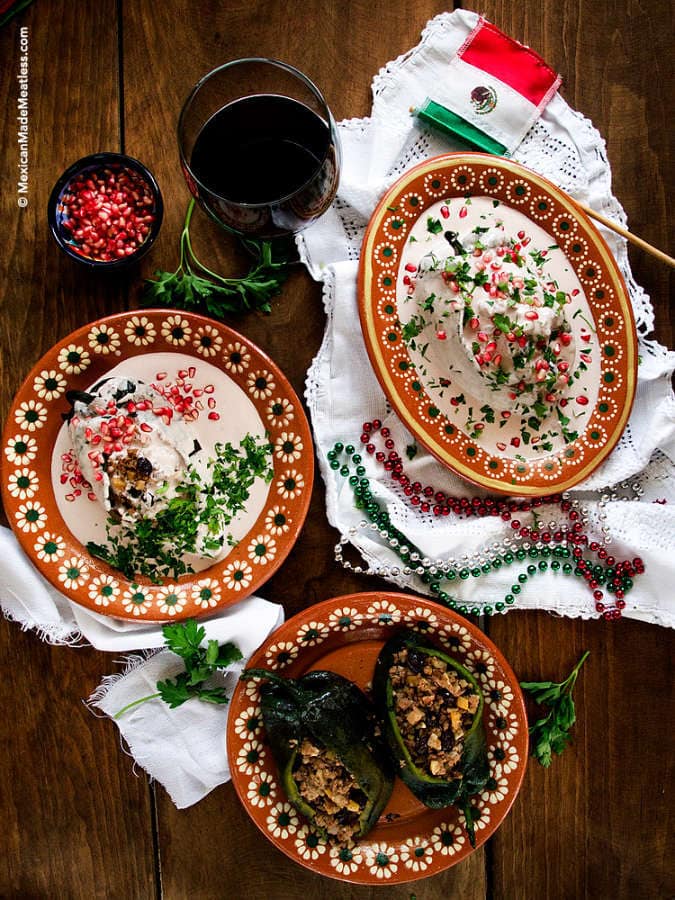 A plate of Mexican stuffed poblano peppers with a creamy walnut sauce, called chiles en nogada. They are a traditional Mexican Independence Day food.