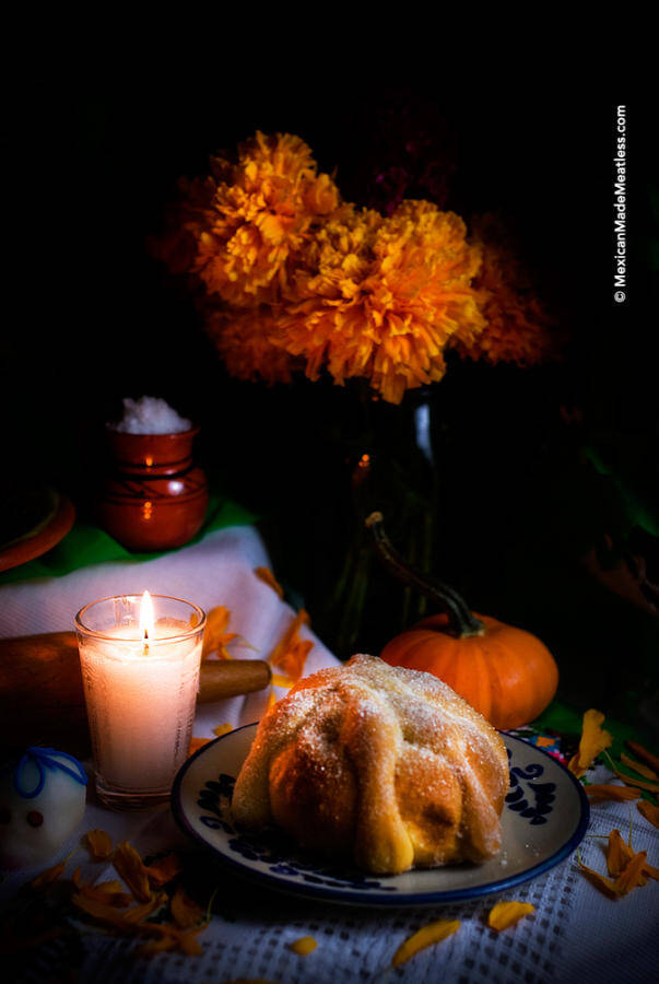 Day of the Dead Bread on a plate places on an altar.
