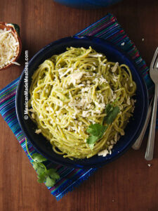 Plate of Mexican green spaghetti made with cream and roasted poblano peppers.