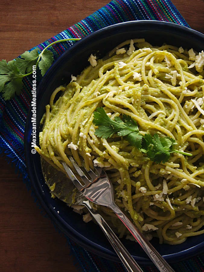 Plate of Mexican green spaghetti made with cream and roasted poblano peppers.