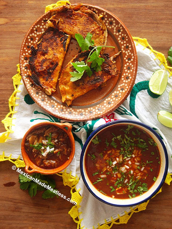 Vegan Birria Tacos or quesabirria tacos served with a bowl of the soup.