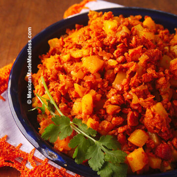 A blue bowl filled with Mexican chorizo sausage and potatoes also called chorizo con papas.