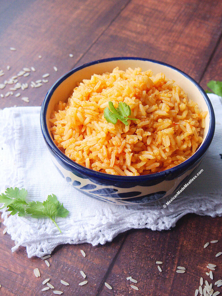 Small bow filled with arroz Mexicano which is Mexican red rice but made vegan.