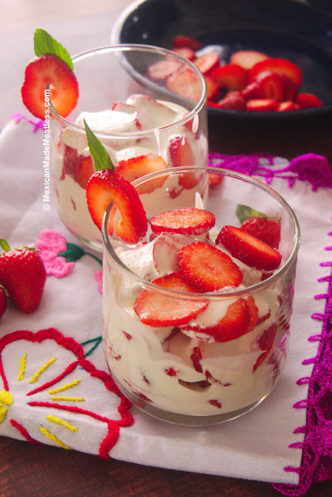 Glass full of Mexican fresas con crema or strawberries and cream.
