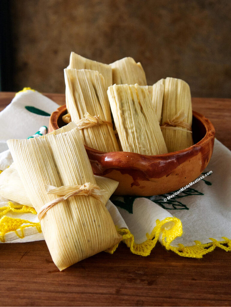Uncooked tamales inside a Mexican bowl. 