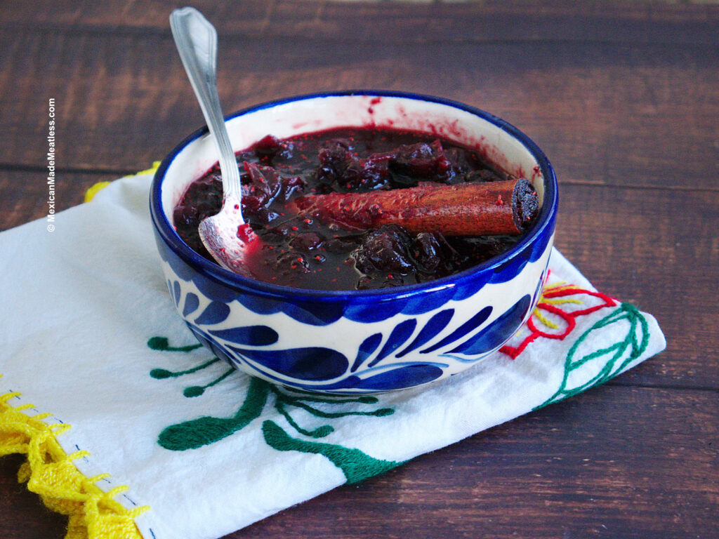 Homemade cranberry sauce with a Mexican touch inside a white and blue bowl.