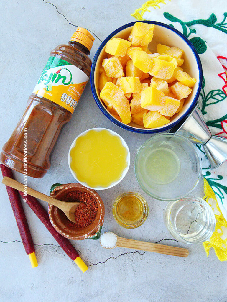 Frozen mango, orange juice, lime juice, tajin, and chamoy areMango Chamoy Margarita Ingredients.