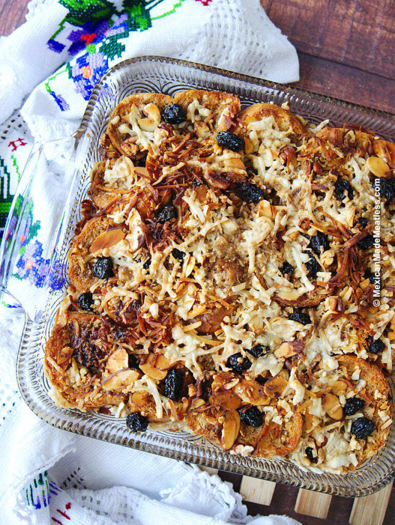 This easy capirotada bread pudding is baked inside a glass baking dish. 