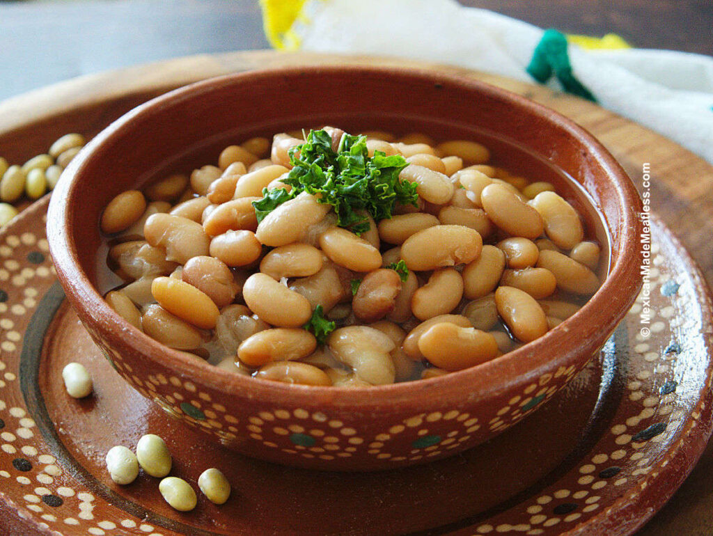 Serving cooked peruvian beans in a Mexican bowl.