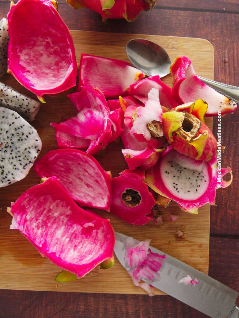 Pink dragon fruit peel on a cutting board.
