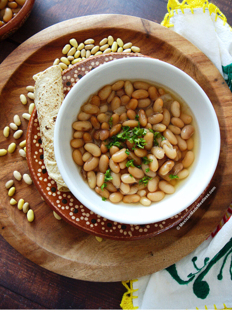 Mexican Peruvian beans or peruano beans cooked and inside a white bowl. 