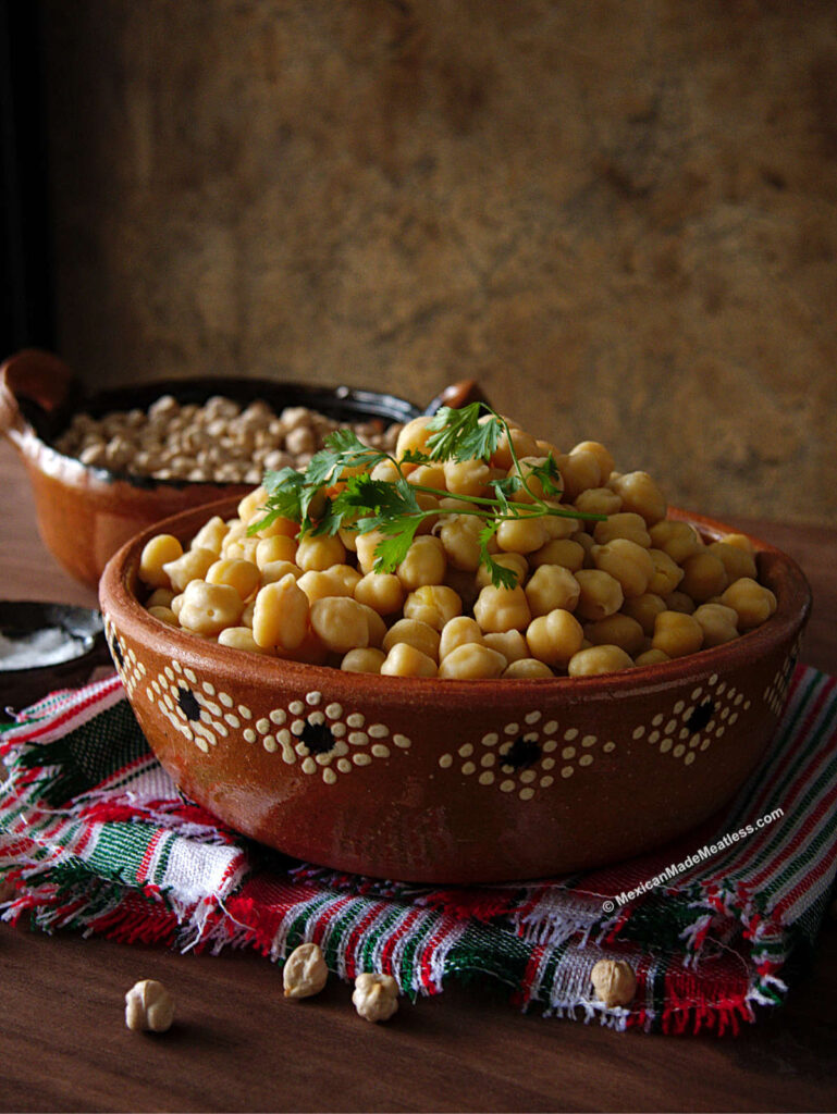 A decorative Mexican bowl filled with garbanzo beans cooked in the Instant Pot.