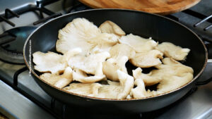 Mushrooms inside a frying pan to make vegan steak tacos.