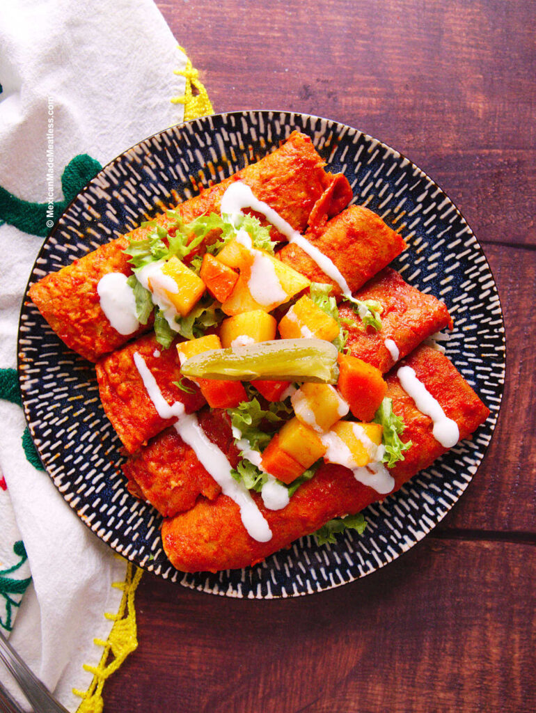 Enchiladas mineras or rolled up enchiladas rojas filled with cheese. 