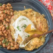 Vegetarian Hatch green chile enchiladas with a fried egg.