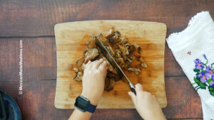 Chopping up cooked oyster mushrooms to use in Making Mexican steak.