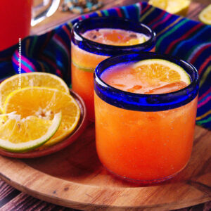 Papaya drink or papaya and orange agua fresca inside small glasses.