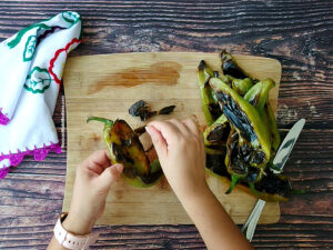 Peeling roasted green hatch chiles.