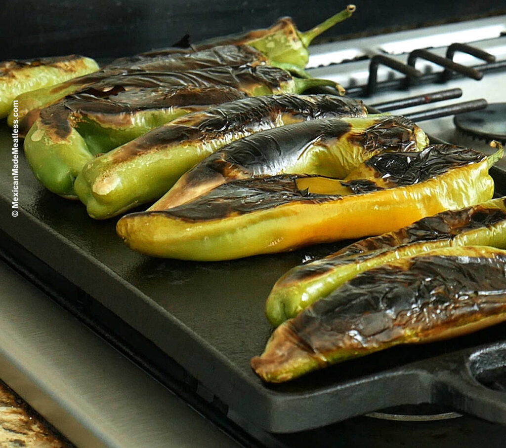 Roasting New Mexico Hatch Chiles on a flat grill.