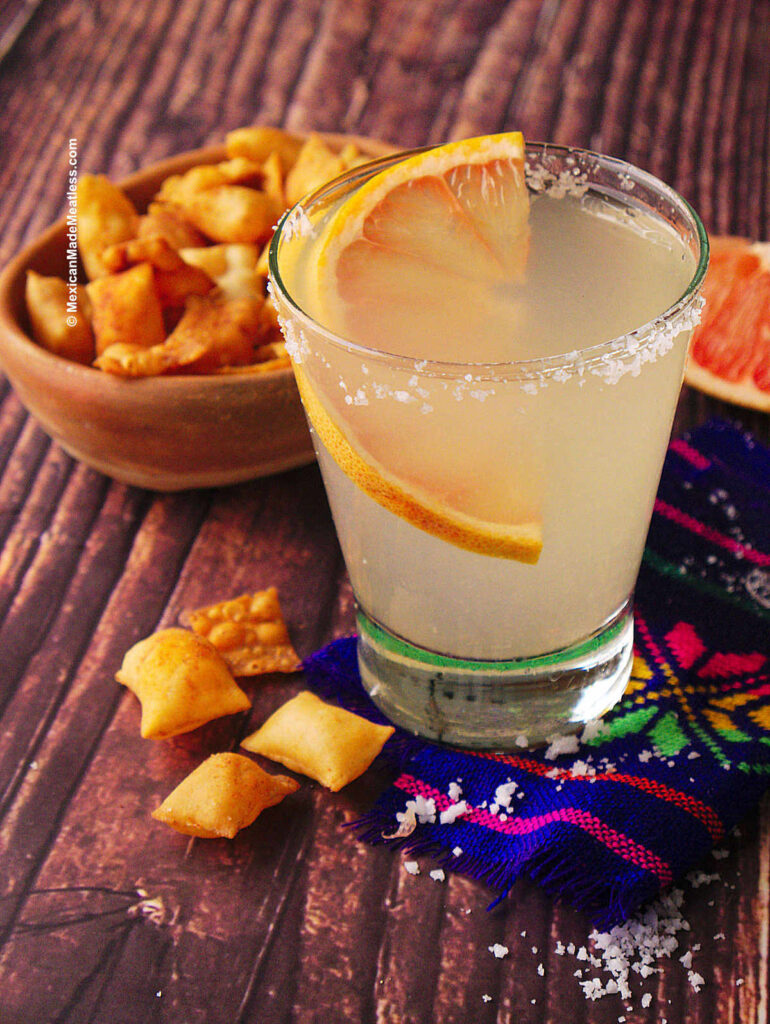 Mexican grapefruit paloma cocktail served with a salty, spicy snack. 