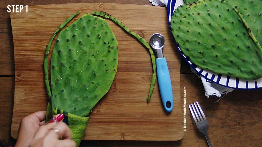 Slicing off the edges of a nopal cactus paddle. 