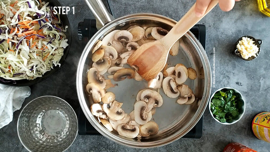 Sautéing slice mushrooms to make vegan eggroll bowls. 
