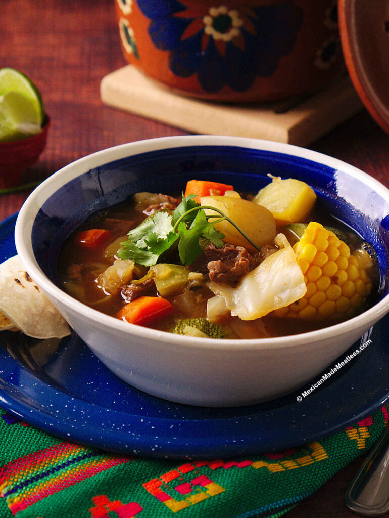 A blue and white bowl filled with Mexican vegan caldo de res or vegan beef stew.