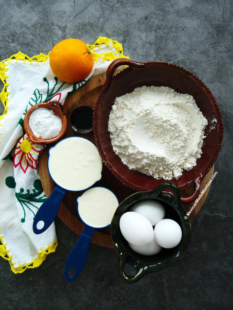 Ingredients to make Mexican nata pound cake. They are flour, nata clotted cream, eggs, sugar, baking powder, salt and orange zest.