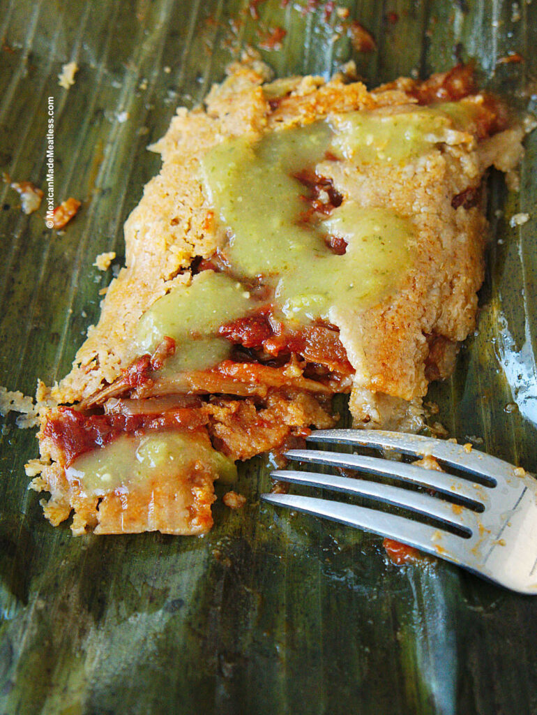 One red meat tamale on a banana leaf. 