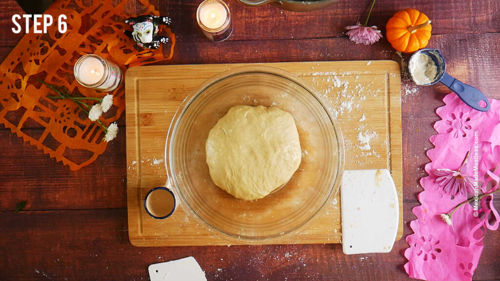 Day of the Dead bread dough being left to rise inside a large glass bowl.