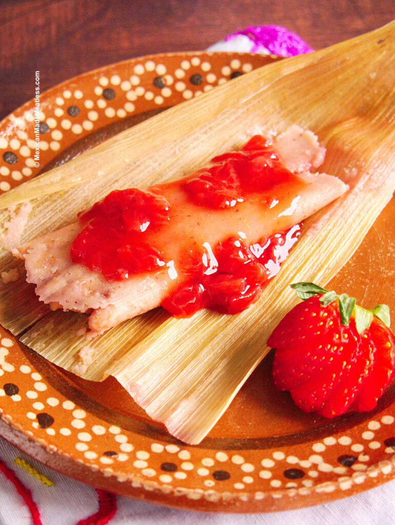 One vegan sweet tamale made with strawberries on a plate.