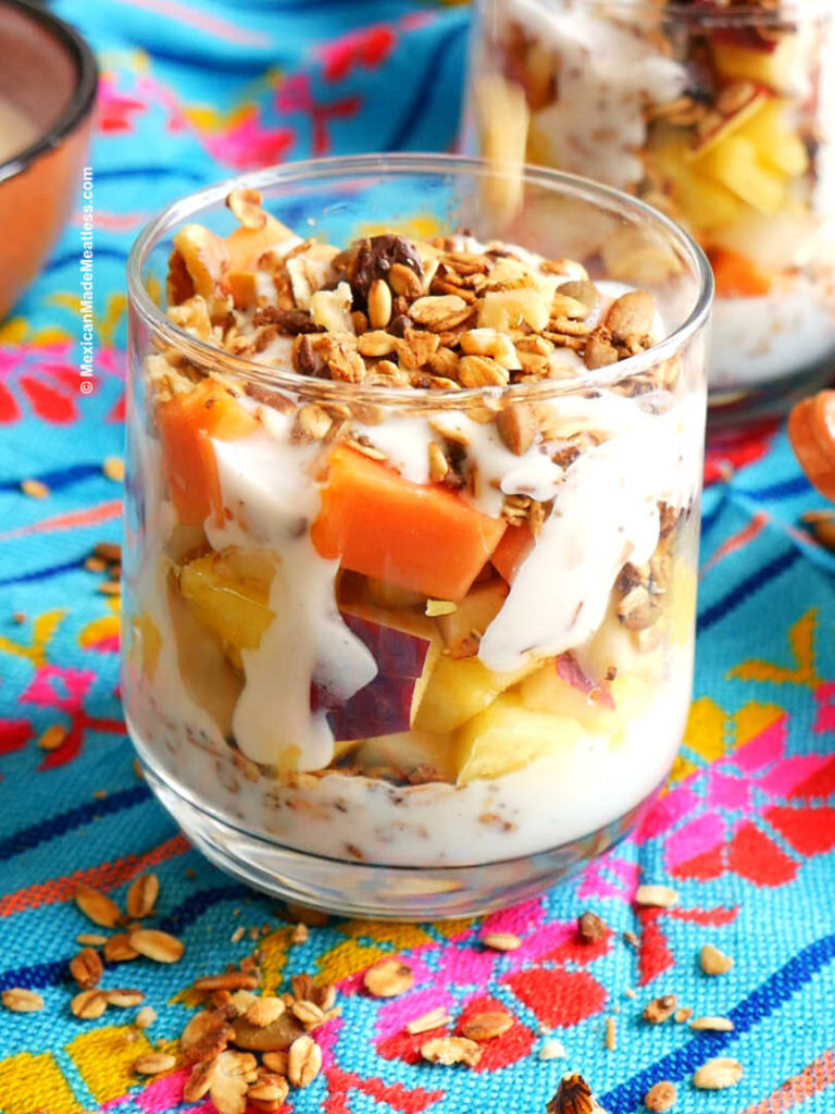 Layering a glass with Mexican fruit salad.
