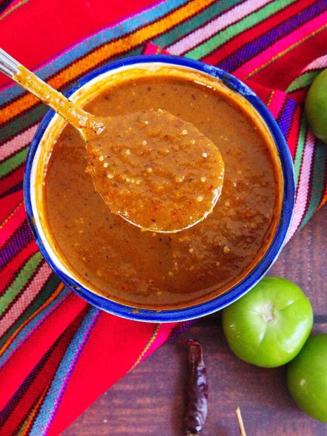 Spoonful of red chile de arbol salsa used for tacos.