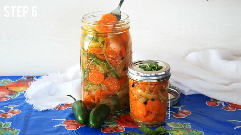 Two mason jars filled with spicy Mexican pickled carrots. 