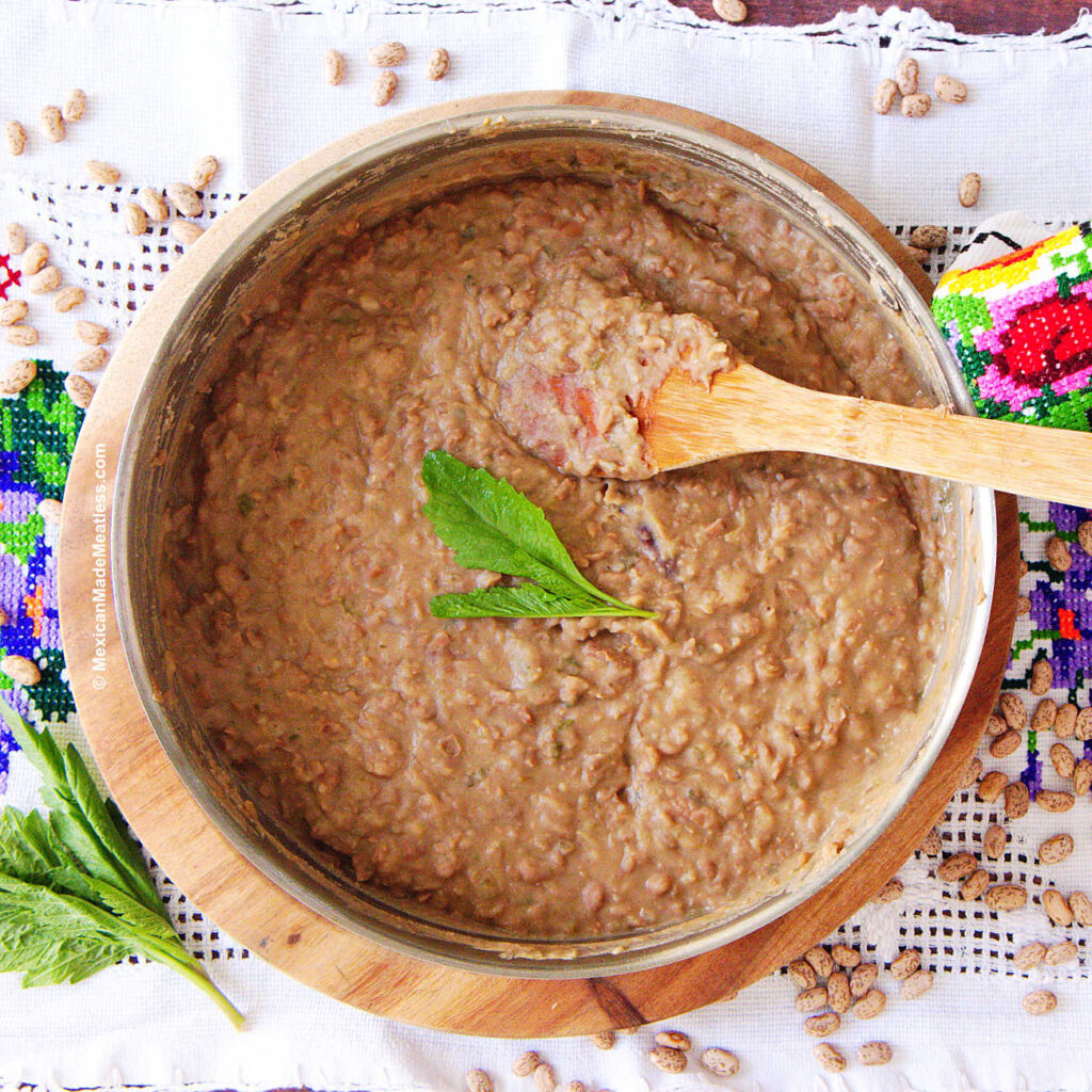 A pan filled with mashed refried beans.