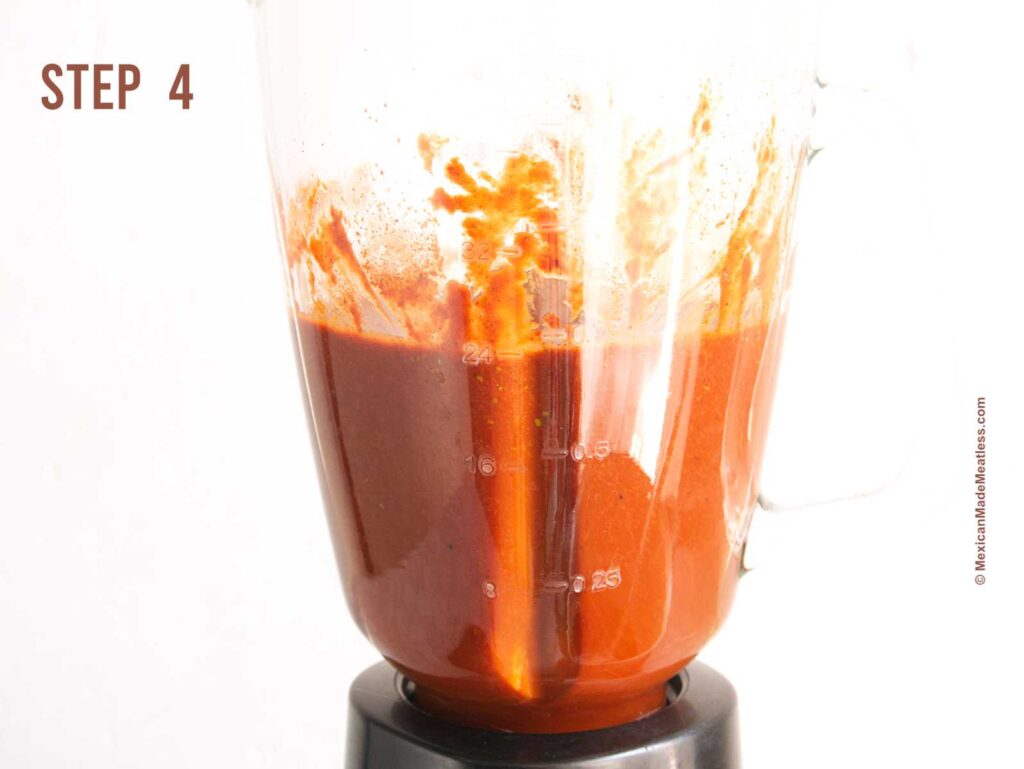 Blender cup blending ingredients to make Mexican soy chorizo.