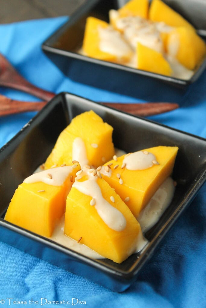 Two small square bowls filled with mango sticky rice.