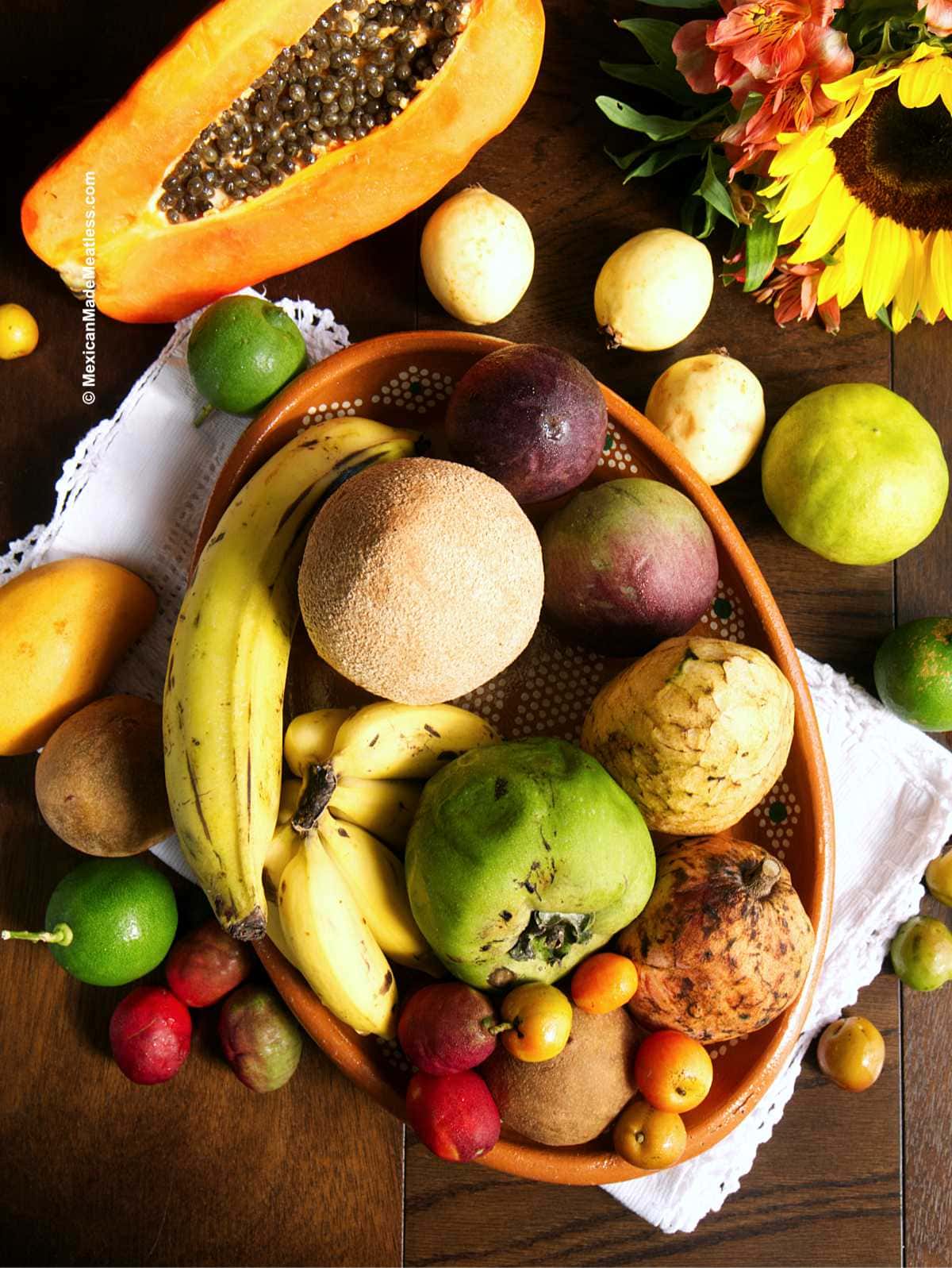 View from above of a wood table filled with exotic Mexican tropical fruits.
