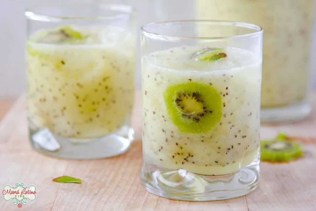 Closeup view of a short glass filled with kiwi agua fresca drink.
