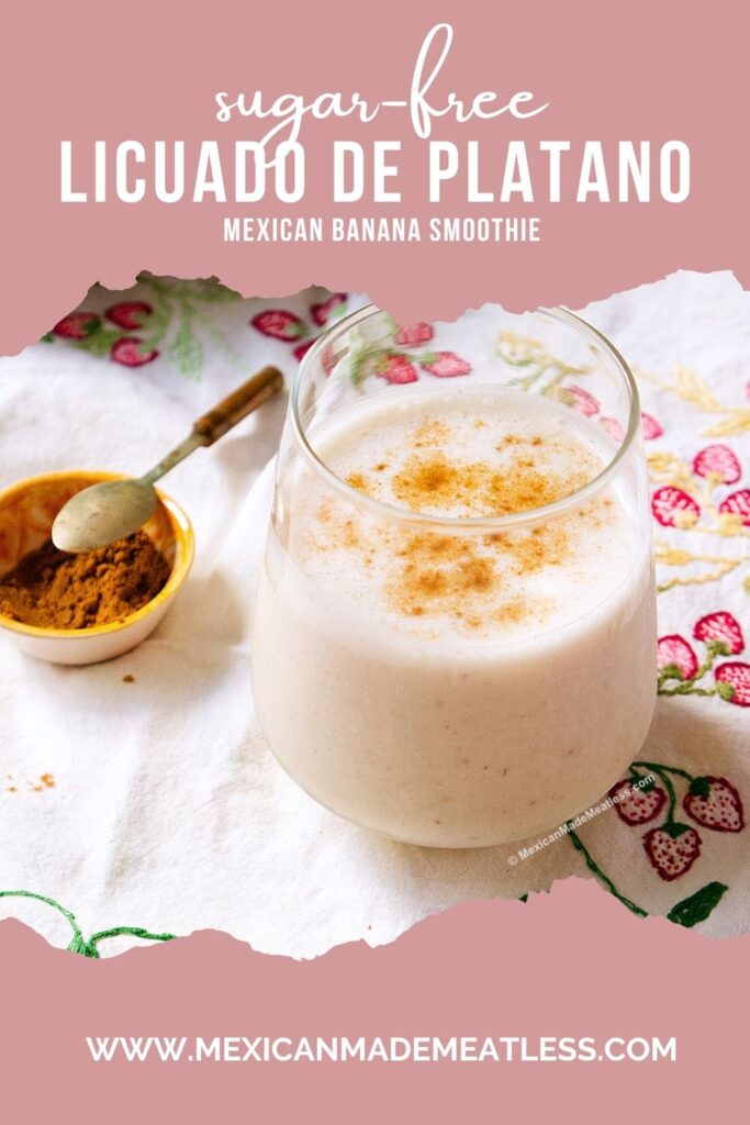 A glass of sugar-free Mexican banana smoothie topped with cinnamon sits on a floral cloth beside a small bowl of ground cinnamon with a spoon. Text above reads "Sugar-free Licuado de Platano, Mexican Banana Smoothie.