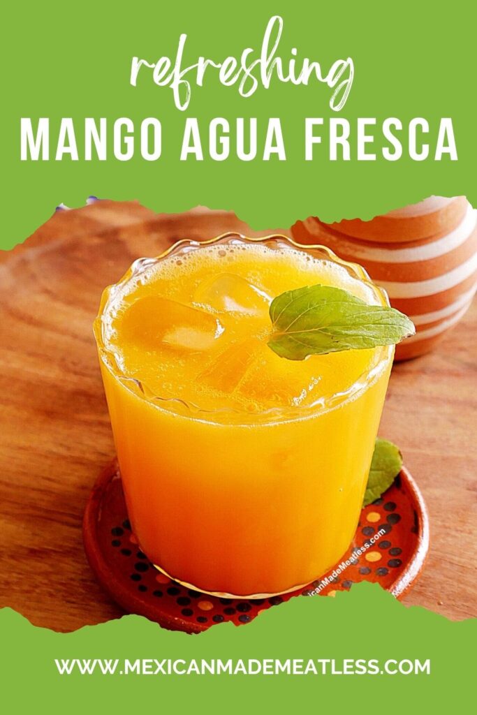 A glass of mango agua fresca with ice and a mint garnish sits on a coaster. Text reads: “Refreshing Mango Agua Fresca” and “www.mexicanmademeatless.com” on a green background.